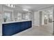 Bright bathroom showcasing a vanity with double sinks, granite counters, and modern lighting at 243 E Wellesley Dr, Clayton, NC 27520