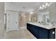 Elegant bathroom featuring double sinks with white marble counters and a glass shower at 243 E Wellesley Dr, Clayton, NC 27520