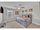 Cozy bedroom with a grey bed, ceiling fan, and plenty of natural light from the window at 243 E Wellesley Dr, Clayton, NC 27520