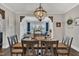 Formal dining room with stylish chandelier and views into a sunroom at 243 E Wellesley Dr, Clayton, NC 27520