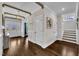 Spacious foyer featuring wood floors, paneled walls, and staircase with white risers at 243 E Wellesley Dr, Clayton, NC 27520