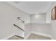 Upstairs landing overlooking staircase with carpet runner and neutral paint at 243 E Wellesley Dr, Clayton, NC 27520