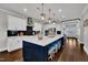 Gourmet kitchen featuring a large island, stainless steel appliances, and pendant lighting at 243 E Wellesley Dr, Clayton, NC 27520
