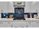 Close up of kitchen with subway tile backsplash and stainless steel range hood at 243 E Wellesley Dr, Clayton, NC 27520