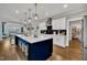 Open concept kitchen featuring a large island with seating and stainless steel appliances at 243 E Wellesley Dr, Clayton, NC 27520