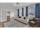 Cozy living room with ample natural light, hardwood floors, and comfortable seating at 243 E Wellesley Dr, Clayton, NC 27520