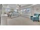 Spacious main bedroom with a large window, tray ceiling, and a cozy seating area at 243 E Wellesley Dr, Clayton, NC 27520