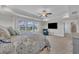 Sunlit main bedroom with plush carpet, a ceiling fan, and a large flat screen tv at 243 E Wellesley Dr, Clayton, NC 27520