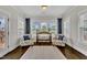 Cozy sunroom with hardwood floors, large windows, and comfortable seating at 243 E Wellesley Dr, Clayton, NC 27520