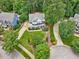 Aerial view of a beautifully landscaped home with mature trees and a long drive way at 244 Elmcrest Dr, Holly Springs, NC 27540