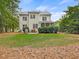 Spacious backyard featuring a screened-in porch, mature trees, and lush green lawn at 244 Elmcrest Dr, Holly Springs, NC 27540