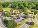 Aerial view of a clubhouse featuring ample parking and verdant scenery at 244 Elmcrest Dr, Holly Springs, NC 27540