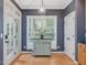Bright dining area with hardwood floors and a light blue island at 244 Elmcrest Dr, Holly Springs, NC 27540
