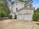 Exterior home elevation featuring a two-car garage, manicured landscaping, and light-colored siding at 244 Elmcrest Dr, Holly Springs, NC 27540