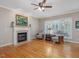 Inviting living room with fireplace, hardwood floors, and comfortable seating, perfect for relaxation at 244 Elmcrest Dr, Holly Springs, NC 27540