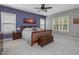 Spacious main bedroom with a wooden bed frame, bench, and artwork at 244 Elmcrest Dr, Holly Springs, NC 27540