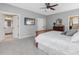 Large main bedroom with hardwood bed frame, access to bathroom, and walk-in closet at 244 Elmcrest Dr, Holly Springs, NC 27540