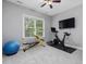 Workout room featuring workout bike, free weights and a mounted television at 244 Elmcrest Dr, Holly Springs, NC 27540