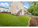 View of the home's backyard with manicured lawn, stairway, and fenced perimeter at 2445 Sapphire Valley Dr, Raleigh, NC 27604