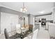 Dining area with a glass table and views to kitchen and other living spaces at 2445 Sapphire Valley Dr, Raleigh, NC 27604