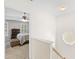 Hallway leading to bedroom featuring neutral walls and wood railing at 2445 Sapphire Valley Dr, Raleigh, NC 27604