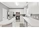 Well-lit kitchen features stainless steel appliances, white cabinetry, and ample counter space at 2445 Sapphire Valley Dr, Raleigh, NC 27604