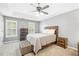 Spacious main bedroom with large windows, a tray ceiling, and carpet flooring at 2445 Sapphire Valley Dr, Raleigh, NC 27604