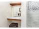Bathroom vanity with wood shelves, marble countertop, mirror, leather stool and tiled shower at 281 Kinsman Ct, Fuquay Varina, NC 27526