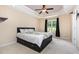 Serene bedroom with neutral tones, tray ceiling, and a large window for natural light at 281 Kinsman Ct, Fuquay Varina, NC 27526