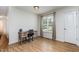 Bright bedroom with hardwood floors and a desk with a chair next to a large window at 281 Kinsman Ct, Fuquay Varina, NC 27526