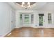 Bright dining area with tray ceiling, chandelier, and large windows overlooking backyard at 281 Kinsman Ct, Fuquay Varina, NC 27526