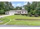 Inviting exterior featuring a manicured lawn, two-car garage, tasteful landscaping, and classic red shutters at 281 Kinsman Ct, Fuquay Varina, NC 27526