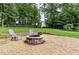 Backyard fire pit area for outdoor entertaining with stone surround and seating at 281 Kinsman Ct, Fuquay Varina, NC 27526