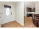 Foyer leading to a modern kitchen with dark wood cabinets, stainless steel appliances, and hardwood floors at 281 Kinsman Ct, Fuquay Varina, NC 27526
