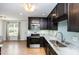 Modern kitchen features stainless appliances, granite counters, tile backsplash and wood flooring at 281 Kinsman Ct, Fuquay Varina, NC 27526