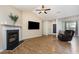Large living room with a fireplace, TV, and wood floors, creating a comfortable and inviting space at 281 Kinsman Ct, Fuquay Varina, NC 27526