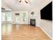 Spacious living room with hardwood floors, fireplace, natural light, and access to the backyard at 281 Kinsman Ct, Fuquay Varina, NC 27526