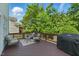 Relaxing back deck with comfortable seating, a grill, and lush greenery at 2933 Creek Moss Ave, Wake Forest, NC 27587