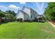 Expansive backyard featuring lush green lawn, wood fence, the deck, and a view of the home's exterior at 2933 Creek Moss Ave, Wake Forest, NC 27587