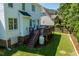Lovely backyard view showcasing a deck with stairs, a propane tank, and partial view of the green lawn at 2933 Creek Moss Ave, Wake Forest, NC 27587