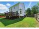 Large backyard features green grass, a wood deck with seating, and the home's exterior at 2933 Creek Moss Ave, Wake Forest, NC 27587