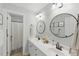 The bathroom features a double sink vanity with a circular mirror at 2933 Creek Moss Ave, Wake Forest, NC 27587