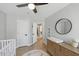 Light-filled Bedroom with a changing table, wood floors, a ceiling fan and a cute whale rug at 2933 Creek Moss Ave, Wake Forest, NC 27587
