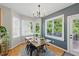 Light-filled dining area with large windows, chandelier, and wood flooring at 2933 Creek Moss Ave, Wake Forest, NC 27587