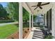 Inviting front porch featuring a swing, comfortable seating, and elegant white columns at 2933 Creek Moss Ave, Wake Forest, NC 27587