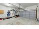 Spacious garage with ample storage space, tools, and a gray garage door at 2933 Creek Moss Ave, Wake Forest, NC 27587