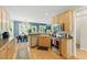 Bright, open kitchen with stainless steel appliances, hardwood floors, and a cozy dining area at 2933 Creek Moss Ave, Wake Forest, NC 27587