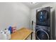 Modern laundry room equipped with a washer and dryer with a wooden table at 2933 Creek Moss Ave, Wake Forest, NC 27587