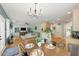 Open concept living space with hardwood floors connecting dining, kitchen, and living room at 2933 Creek Moss Ave, Wake Forest, NC 27587