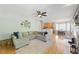 Spacious living area featuring hardwood floors, a large sectional, and an open layout to the kitchen at 2933 Creek Moss Ave, Wake Forest, NC 27587
